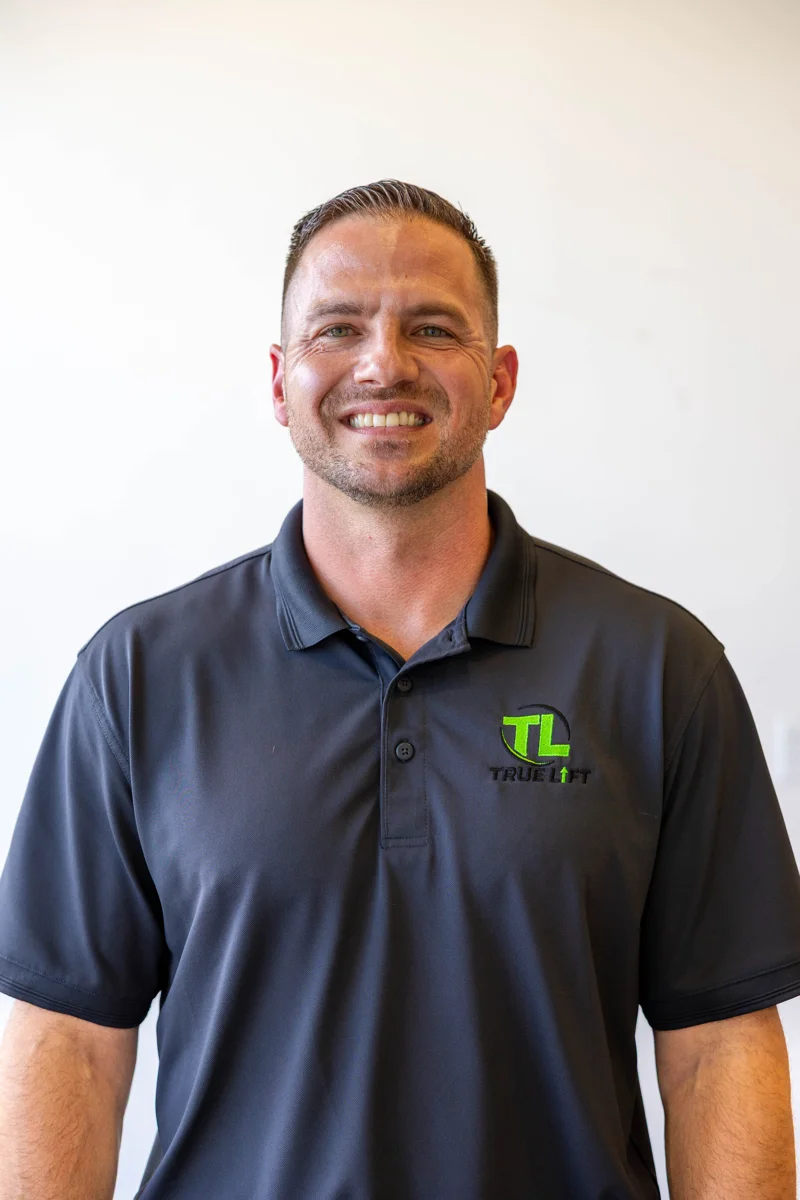 Chris, co-owner of True Lift Garage Doors, in a charcoal company polo.