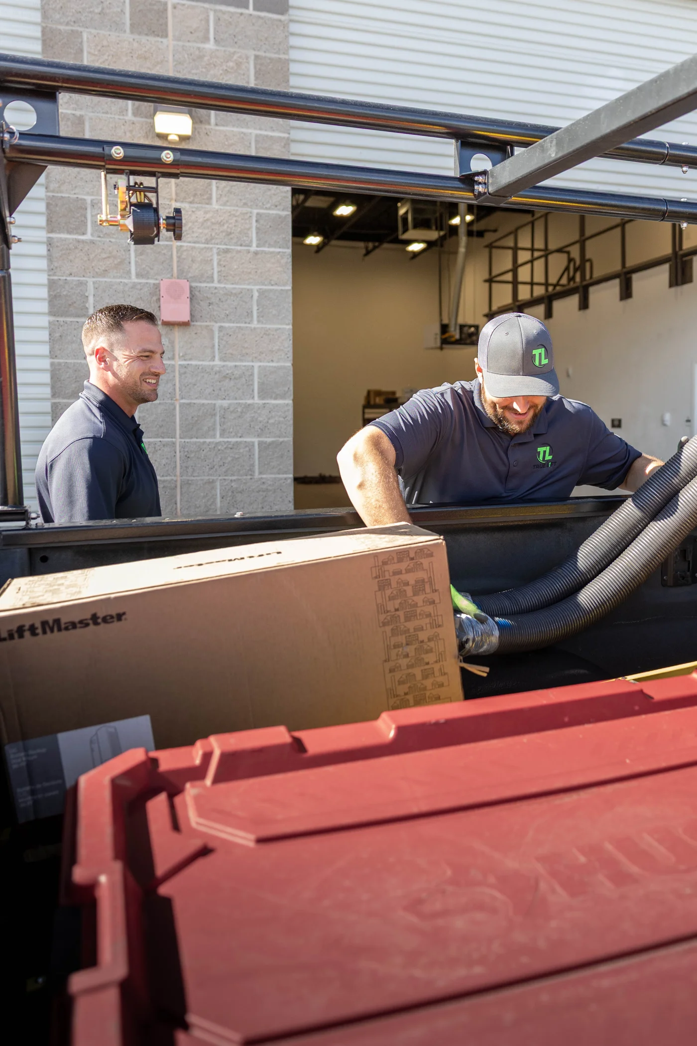 Chris and Colin loading parts into the True Lift service truck.