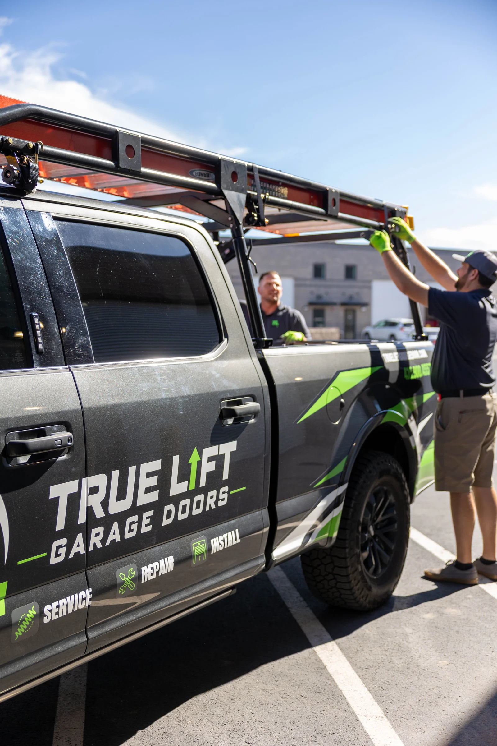 True Lift team securing equipment on their garage door service truck.